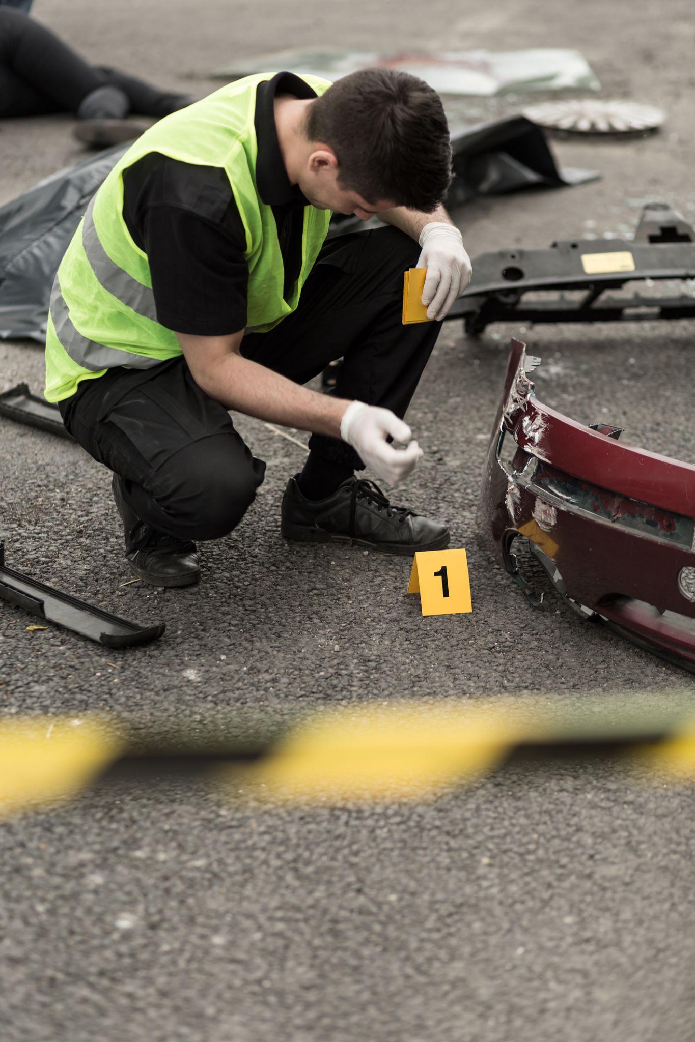 Investigator documenting evidence at an accident scene